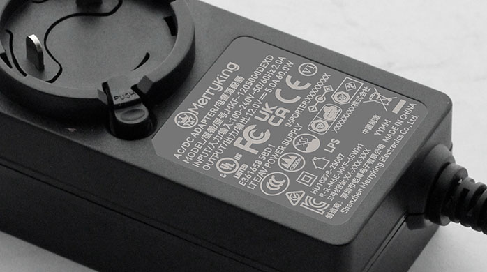 High-Detail Macro Photography of Power Adapter Safety Rating Label