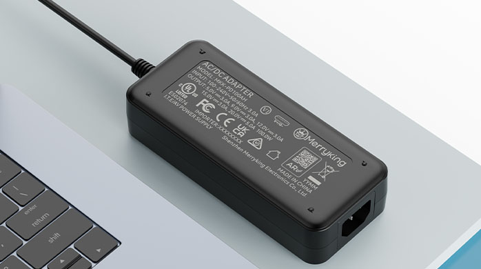 Power rating label on a dual voltage laptop adapter block