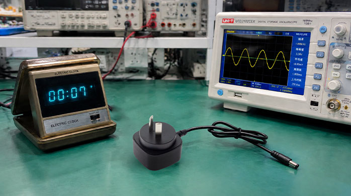 Oscilloscope and vintage clock in an engineering frequency test lab